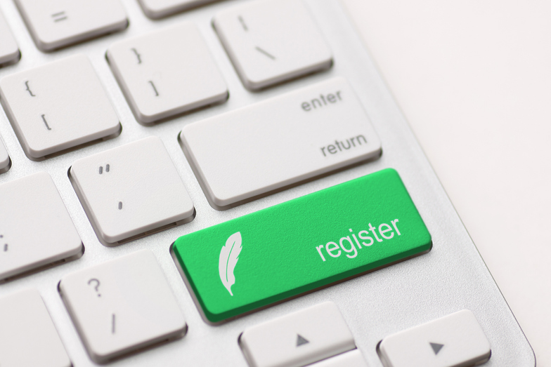 A keyboard with a key containing the words 'register'